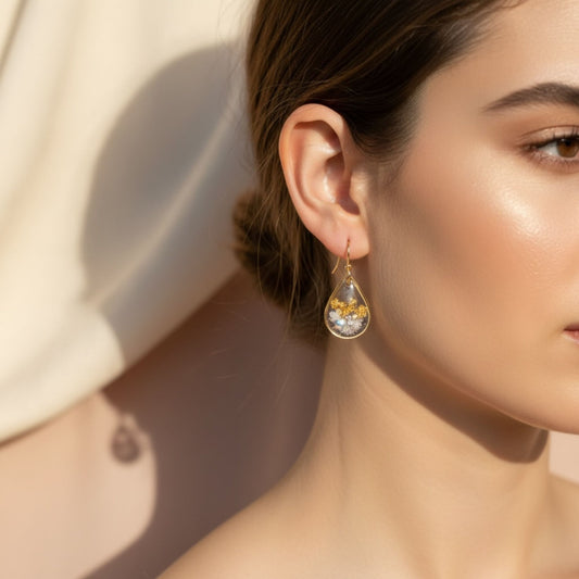 Woman wearing Golden Light Australian handmade earrings with gold leaf and soft shimmer by Katie Tilson Studios