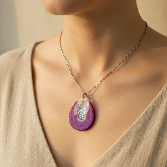 Australian handmade resin necklace with a purple pendant worn by a person against a neutral background.