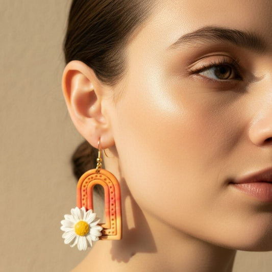 Close-up of a woman wearing Sunrise Daisy Arches colorful statement dangle earring with a daisy design.