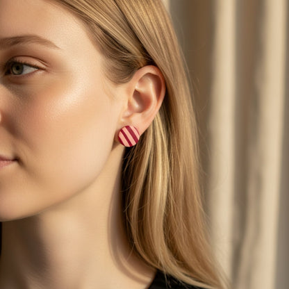 Australian handmade stud earrings Berry Stripe in round shape with pink stripe design worn on ear.