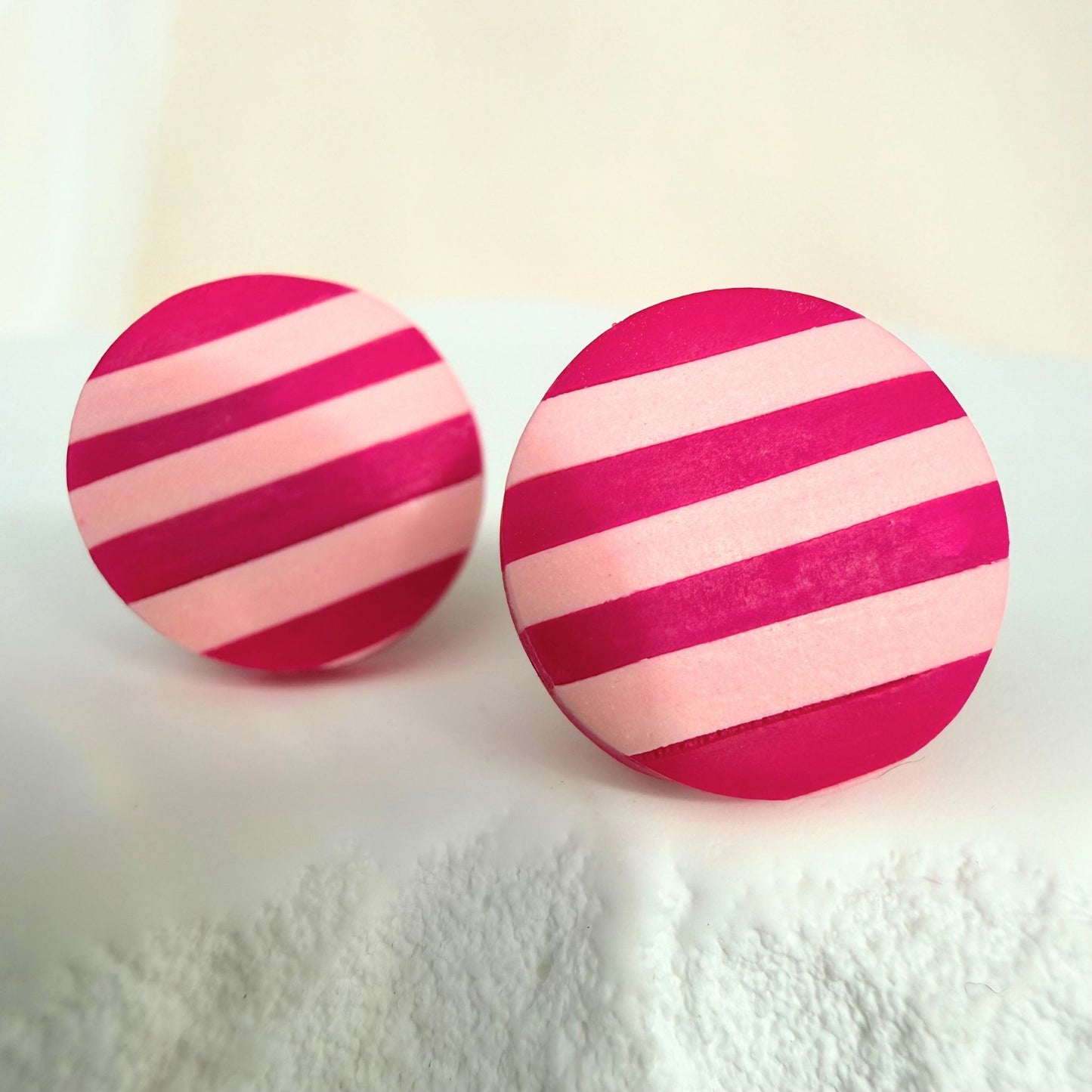 Australian handmade dark pink and pastel pink striped stud earrings on a textured white surface.