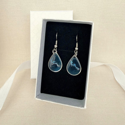 Coastal Glow handmade resin dangle earrings resting on black velvet insert in white gift box