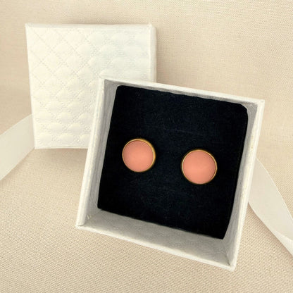 Pair of Australian handmade blush pink earrings with gold bezel in a white box on a beige background.