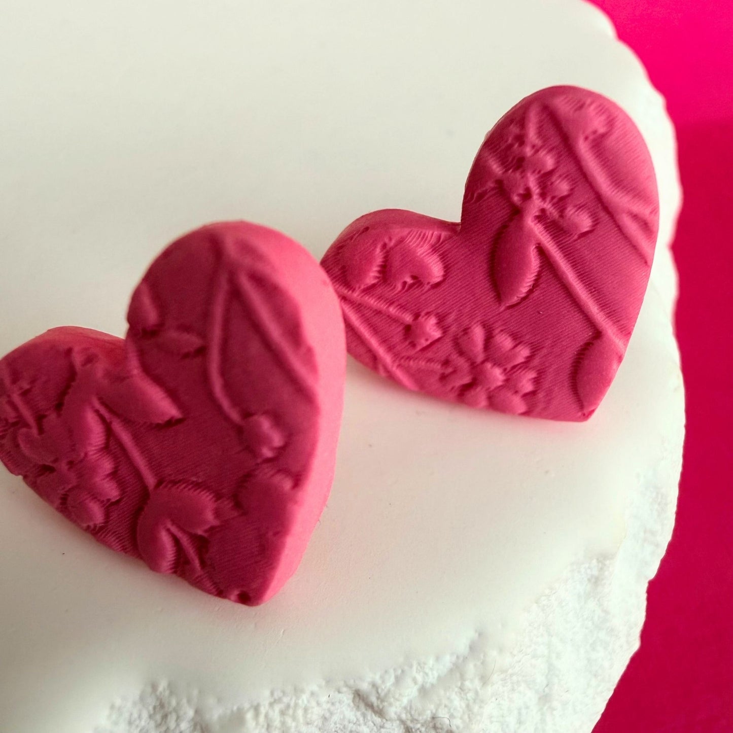 Close up of lightweight handmade stud earrings Floral Hearts