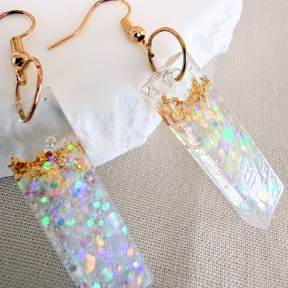 Close up of lightweight dangle earrings Gilded Shore - clear resin with gold leaf and white shimmer embedded.