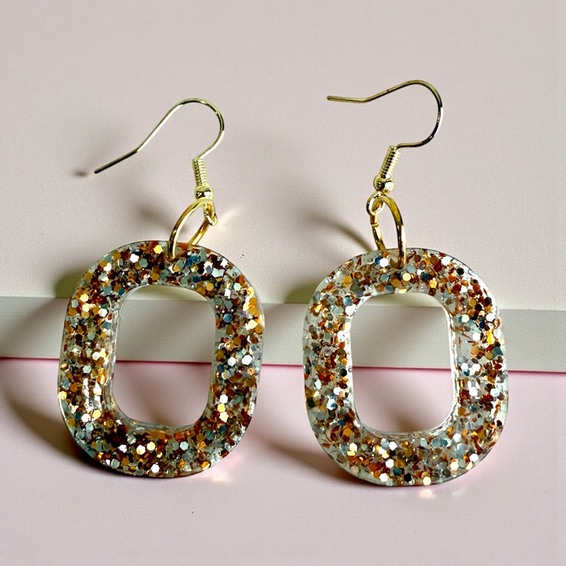 gold and silver glitter oval shaped resin dangle earrings