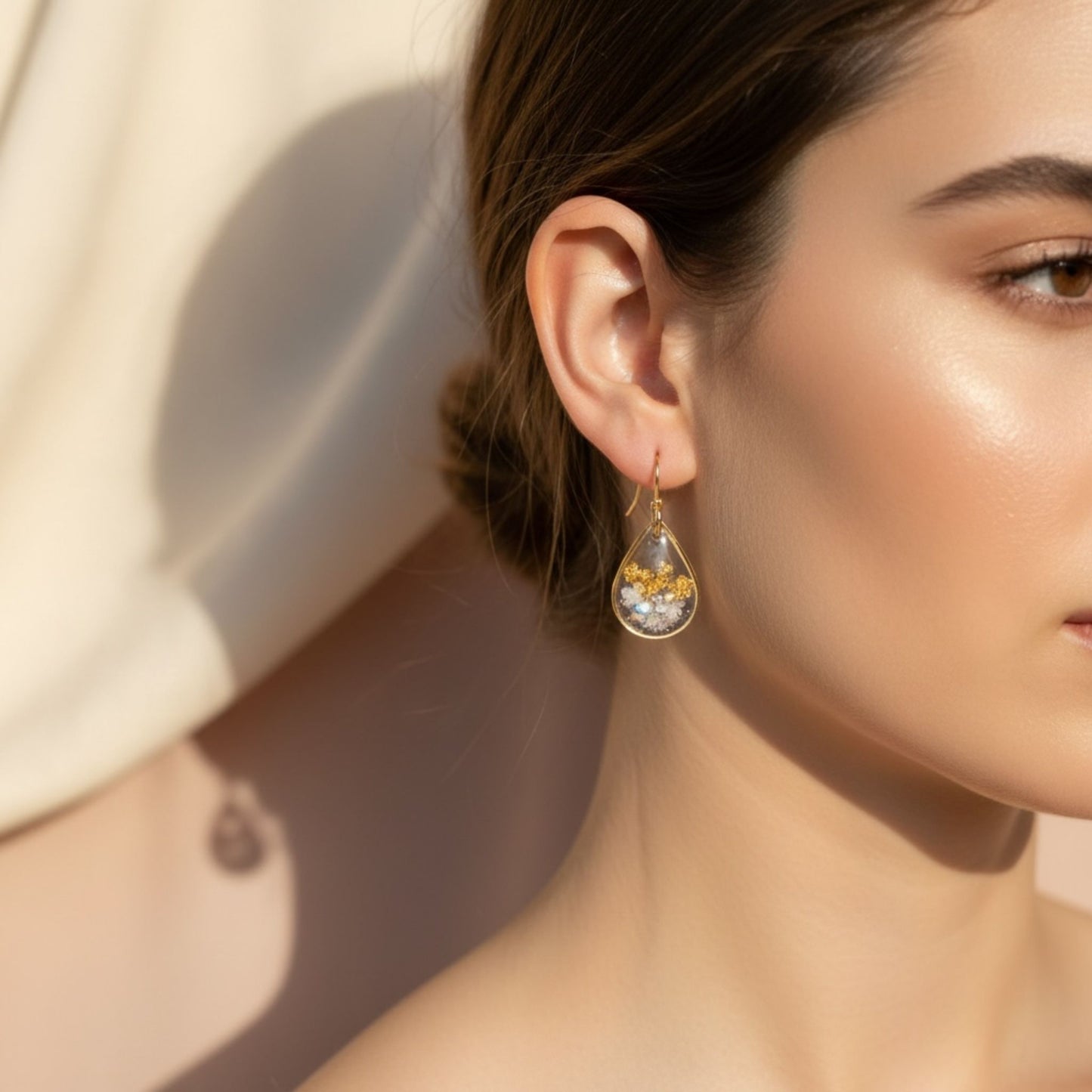 Woman wearing Golden Light Australian handmade earrings with gold leaf and soft shimmer by Katie Tilson Studios