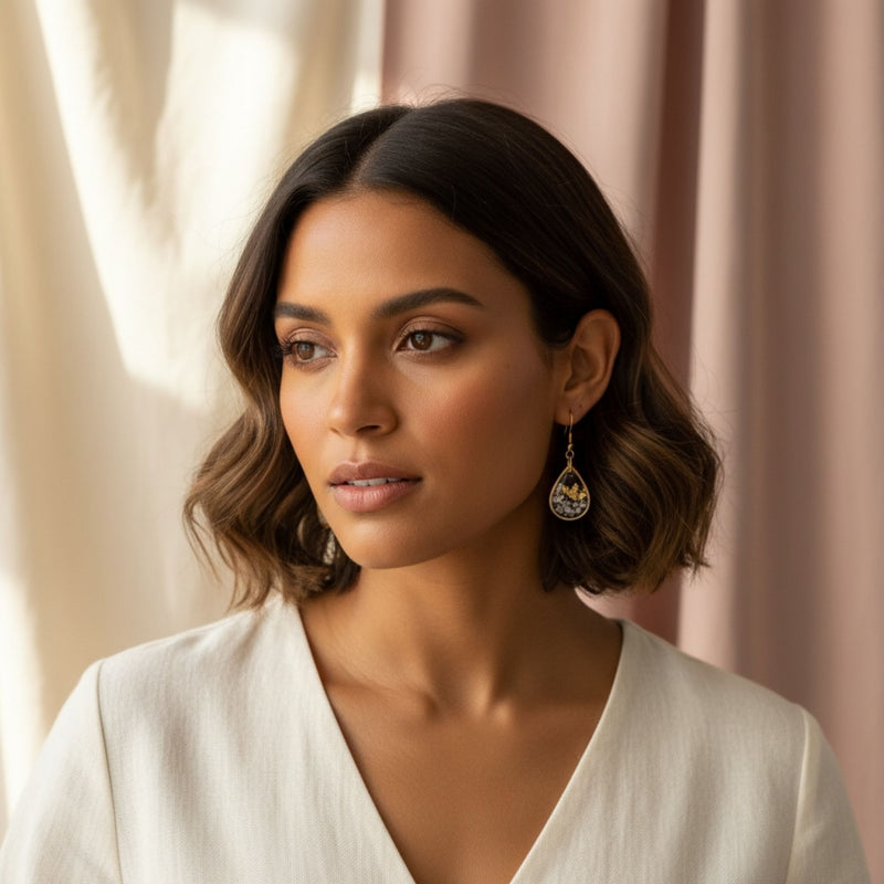 Model wearing Golden Light earrings in clear resin with gold accents, handmade in Australia by Katie Tilson Studios