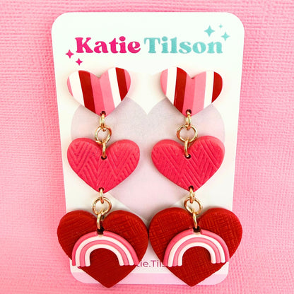 Australian handmade statement drop earrings in heart shaped design on a Katie Tilson Studios branded earring card against a pink background.