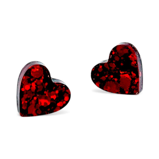 Sparkly resin heart stud earrings in a glossy handmade finish.