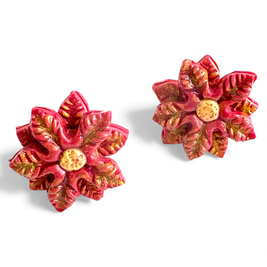 Red poinsettia polymer clay stud earrings with gold shimmer and nickel-free gold studs.