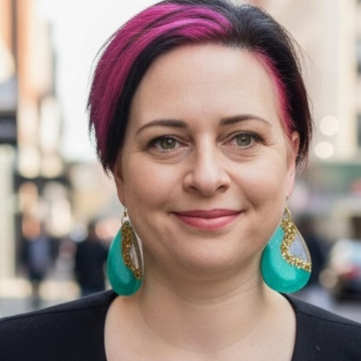 Lifestyle portrait of jewellery artist Katie Tilson wearing her own handmade earrings