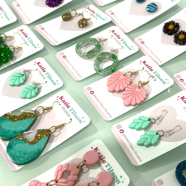Collection of handmade Katie Tilson Studios earrings on display cards ready for posting.