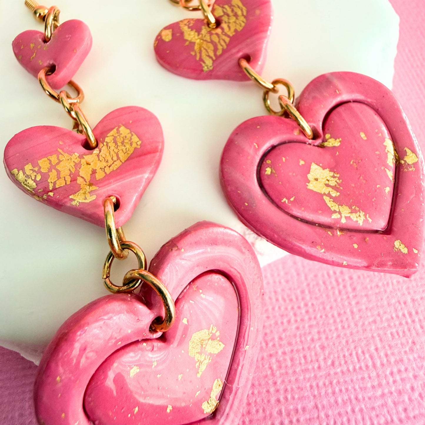 Close up of lightweight handmade dangle earrings Love Letter