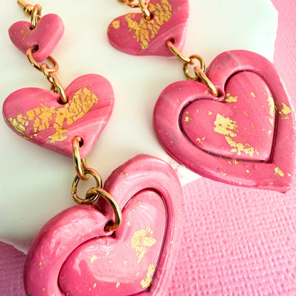 Close up of lightweight handmade dangle earrings Love Letter