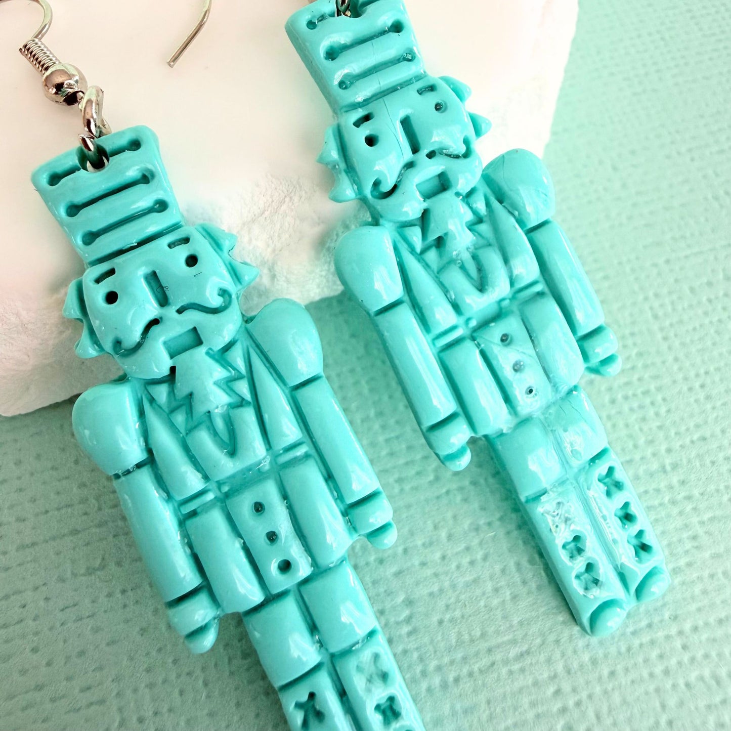 Close up of lightweight handmade dangle earrings Mint Cracker