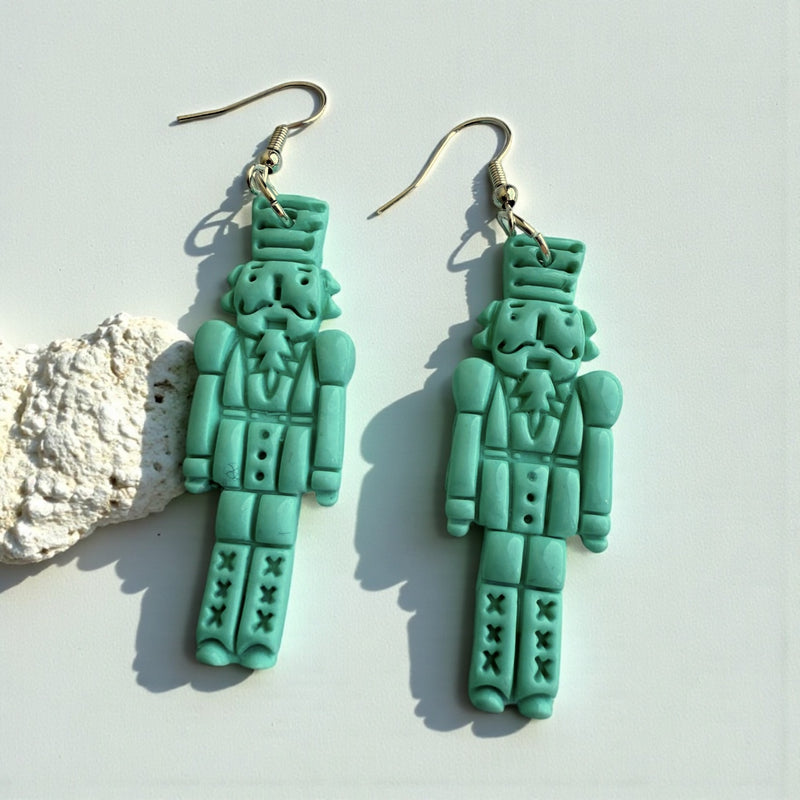 nutcracker design polymer clay dangle earrings in mint green 