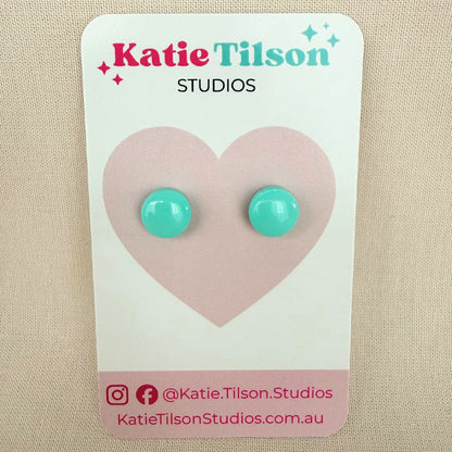 Mint colour circular stud earrings on a Katie Tilson Studios card against a beige background.