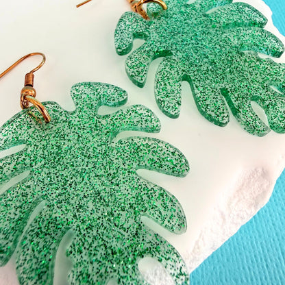 Close up of lightweight handmade dangle earrings Monstera Magic