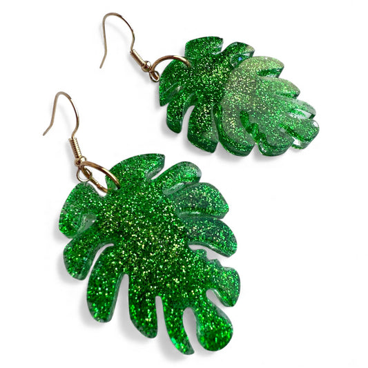 Green glitter Monstera leaf resin dangle earrings with gold nickel-free hooks.