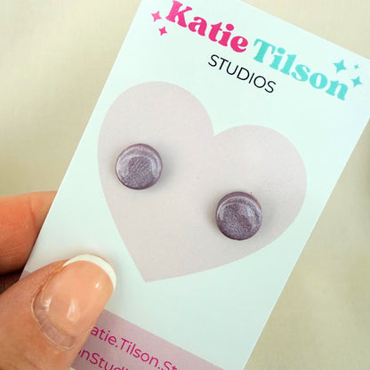 Mulberry colour circular stud earrings on a Katie Tilson Studios card with a hand holding the card.