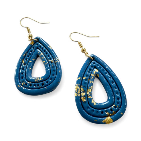 Blue teardrop earrings with gold accents on a white background