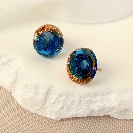 Australian handmade stud earrings Ocean Pebble in translucent teal resin with gold leaf details.