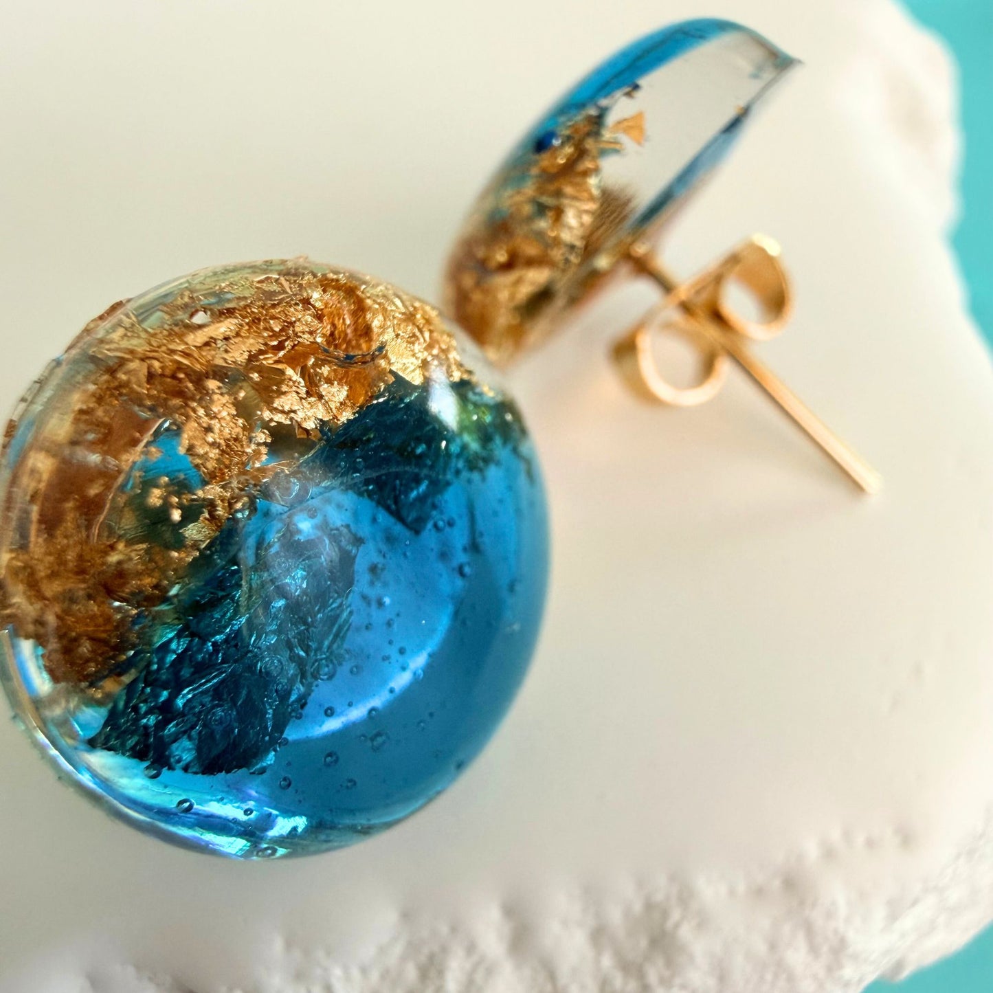 Close up of lightweight handmade stud earrings Ocean Pebble Glow