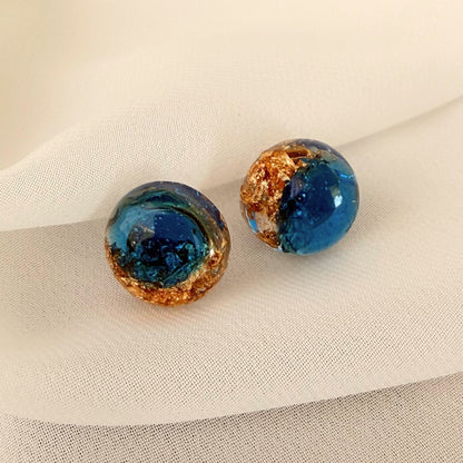 Australian handmade stud earrings Ocean Pebble Glow in teal translucent resin with gold leaf details.