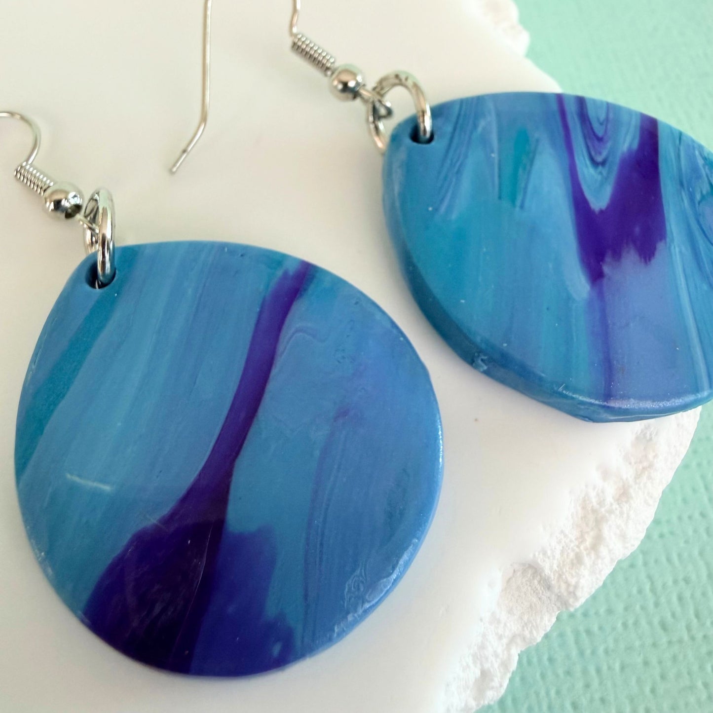 Close up of lightweight handmade dangle earrings Pastel Tide
