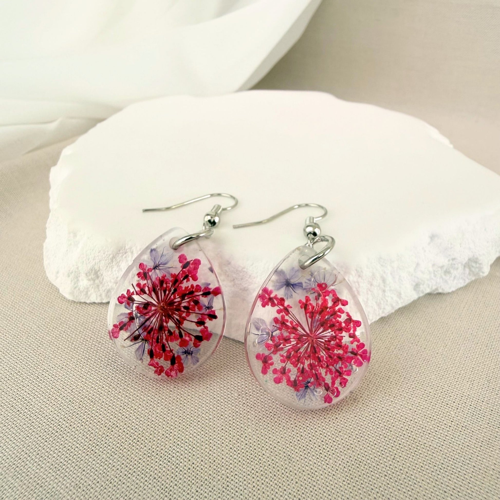Australian handmade dangle earrings Petal Drift Teardrops with pink and purple flowers embedded in transparent resin.