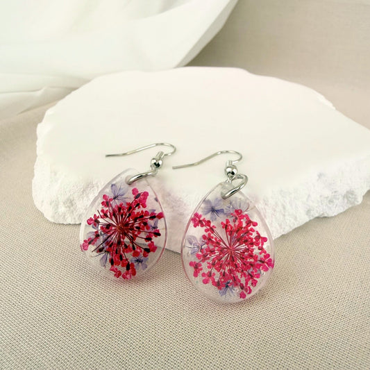 Australian handmade dangle earrings Petal Drift Teardrops with pink and purple flowers embedded in transparent resin.