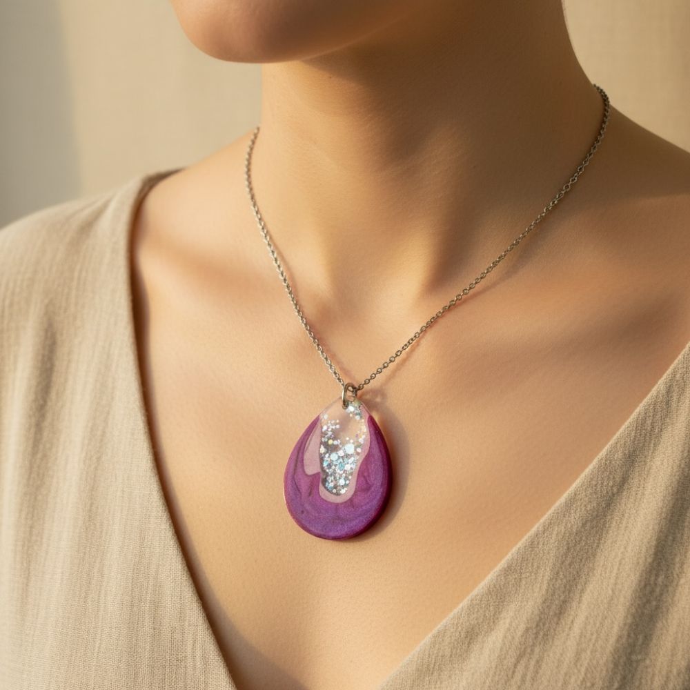 Australian handmade resin necklace with a purple pendant worn by a person against a neutral background.
