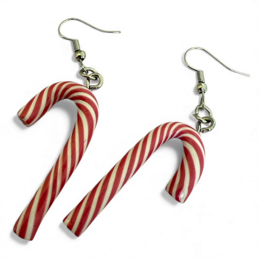 a pair of pink and white striped polymer clay candy cane earrings with silver coloured hooks on a white background