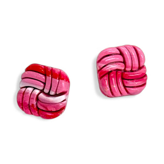 Pink polymer clay stud earrings with a soft marble swirl pattern.