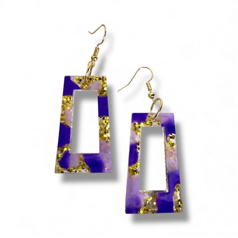 Purple resin dangle earrings with shimmering layers and a glossy shine.