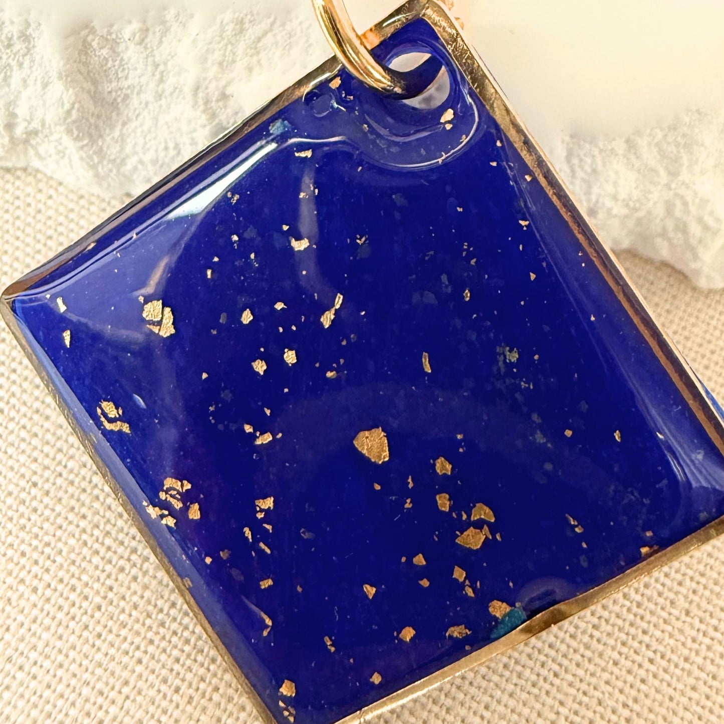 Close up of Shine On cobalt coloured pendant necklace with gold flecks and gold hardware.