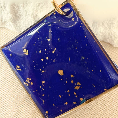 Close up of Shine On cobalt coloured pendant necklace with gold flecks and gold hardware.