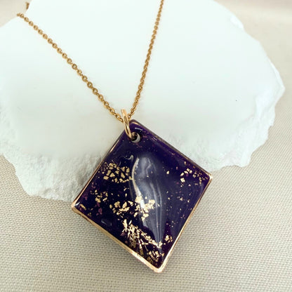 Shine On violet colour handmade pendant necklace in diamond shape with gold leaf detail and glossy finish hanging from gold toned chain.