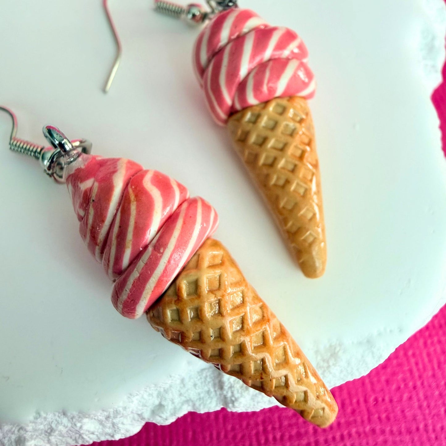 Close up of lightweight handmade dangle earrings Strawberry Swirl Soft Serve Cones