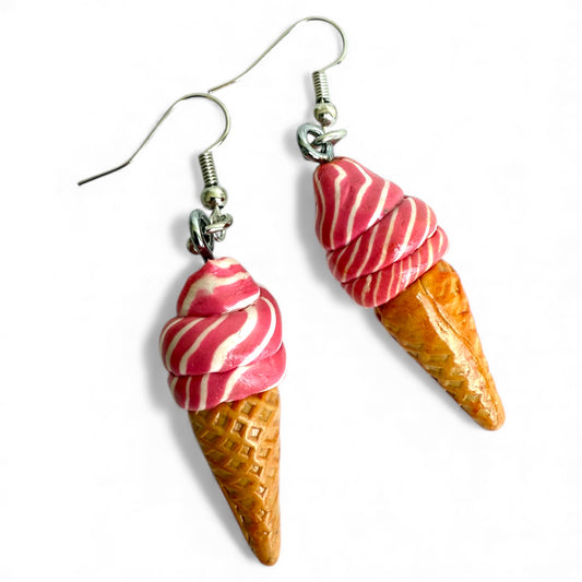 a pair of pink and white soft serve icecream in a cone shaped polymer clay earrings with silver coloured, nickel-free hooks.