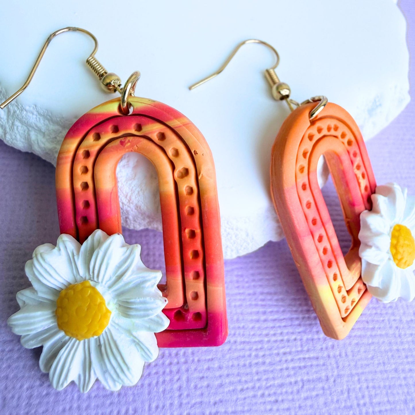 Close-up of lightweight handmade dangle earrings Sunrise Daisy Arches