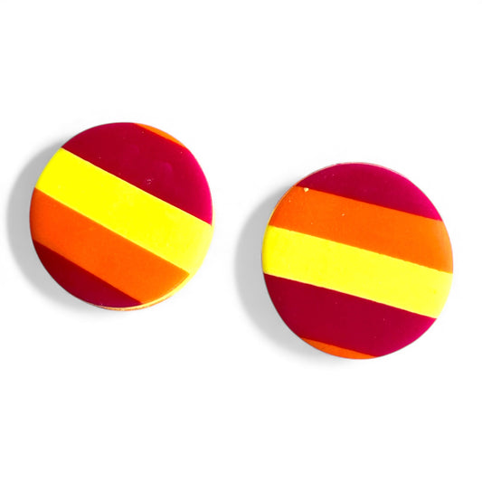 Pair of round stud earrings with pink, orange, and yellow striped design on a white background