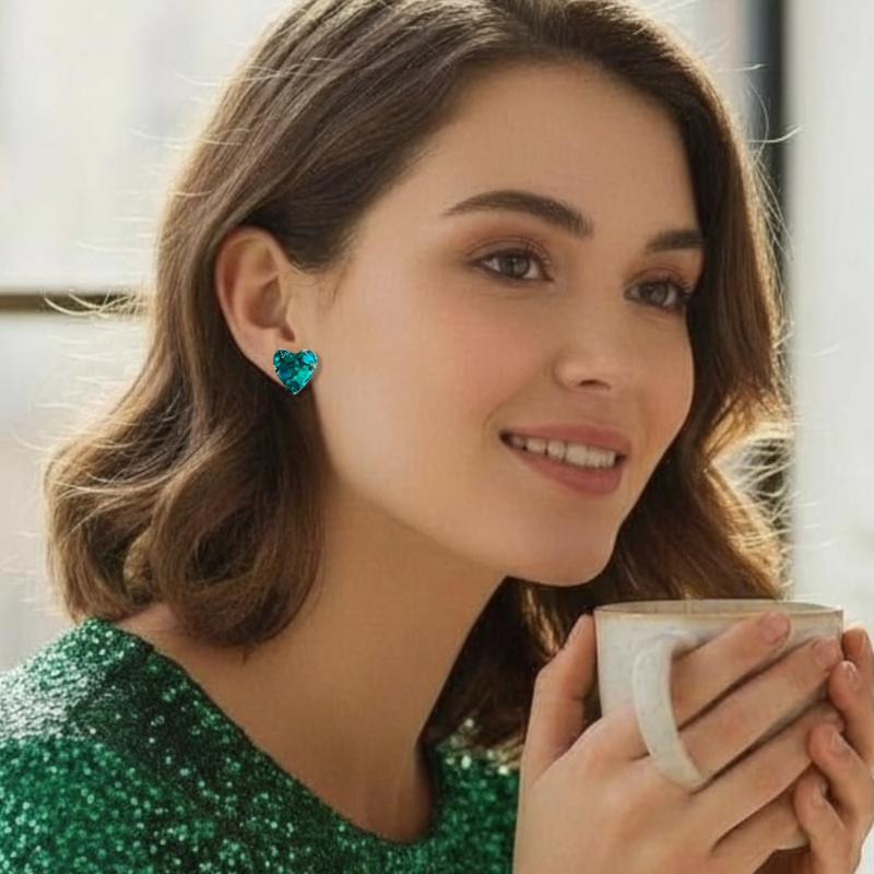 teal glitter resin stud earrings worn on model with a cup of coffee in her hands