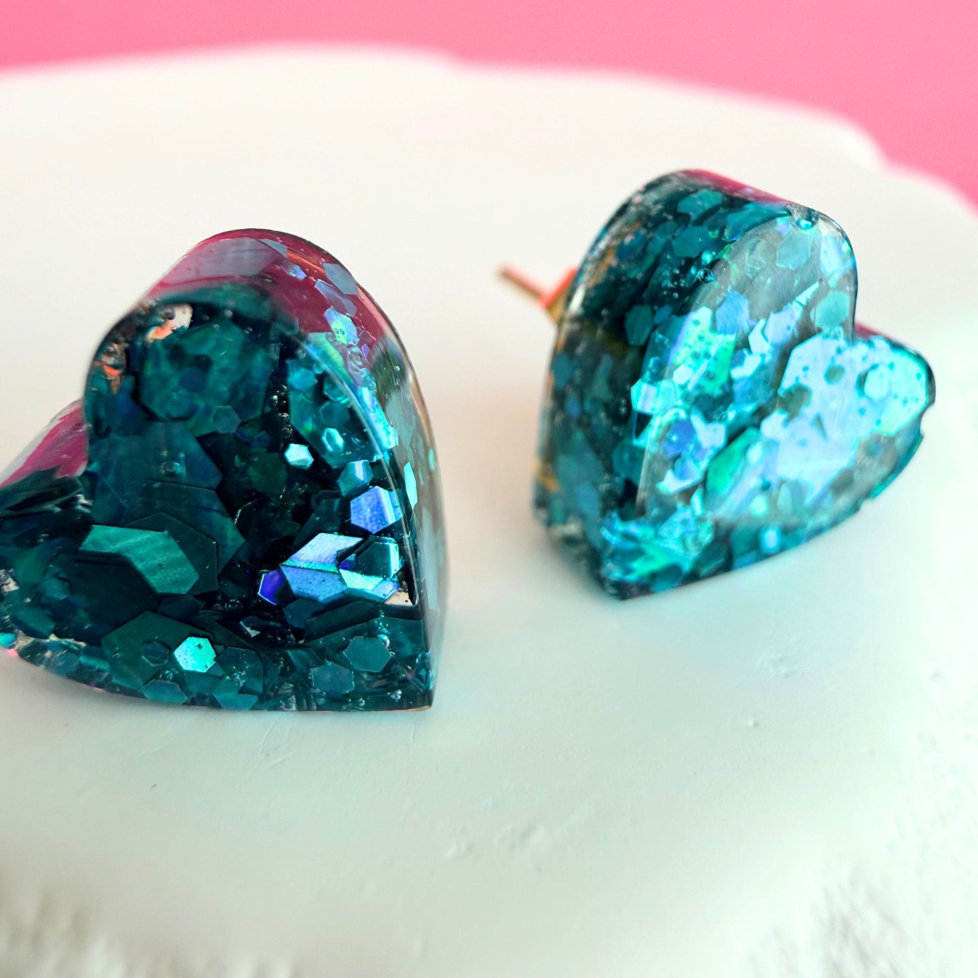 Close-up of lightweight handmade stud earrings Teal Heart