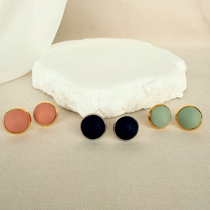 Three pairs of The Everyday Trio round stud earrings in blush, navy and eucalyptus green.