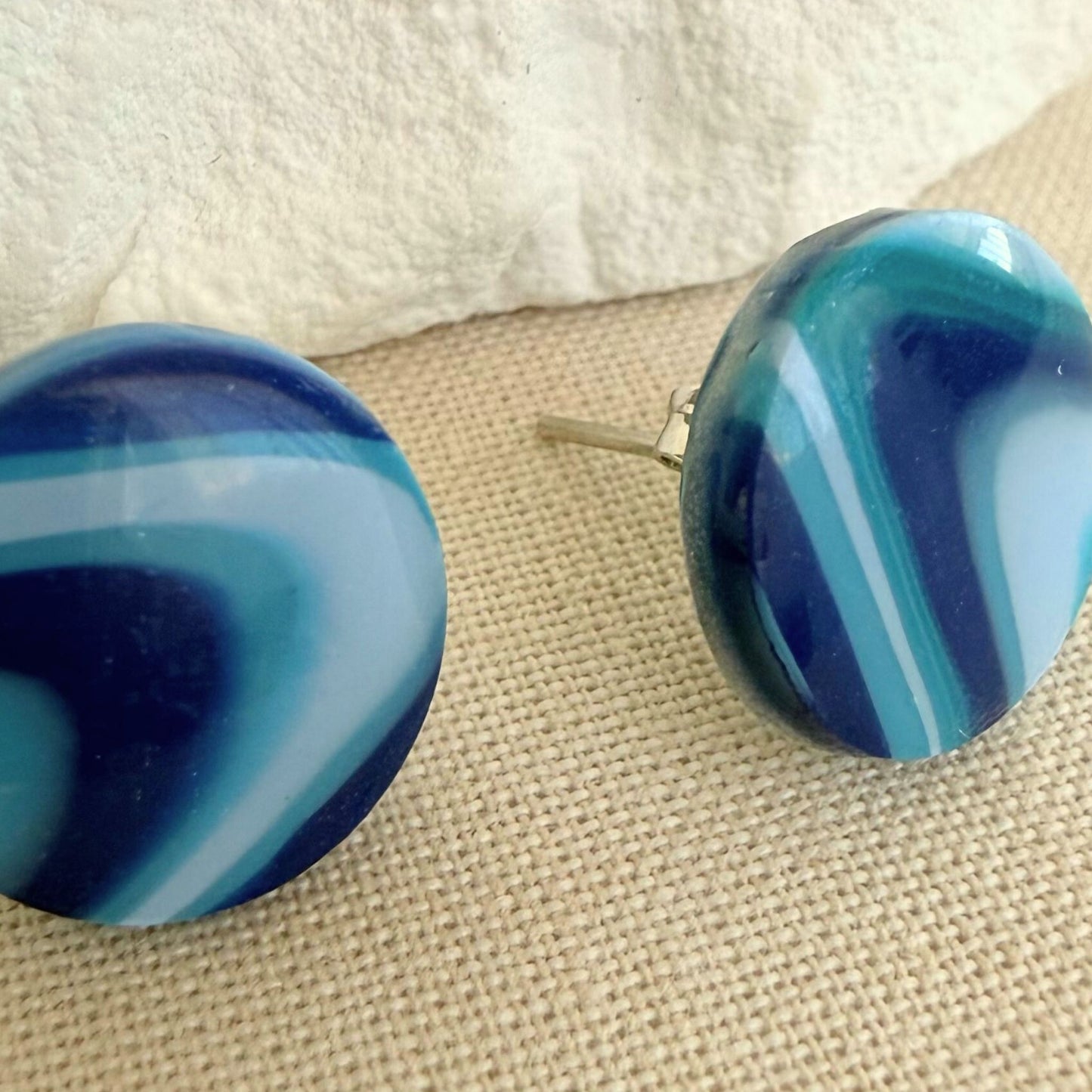 Close up of handmade stud earrings Wavelength in coastal blue wave design.